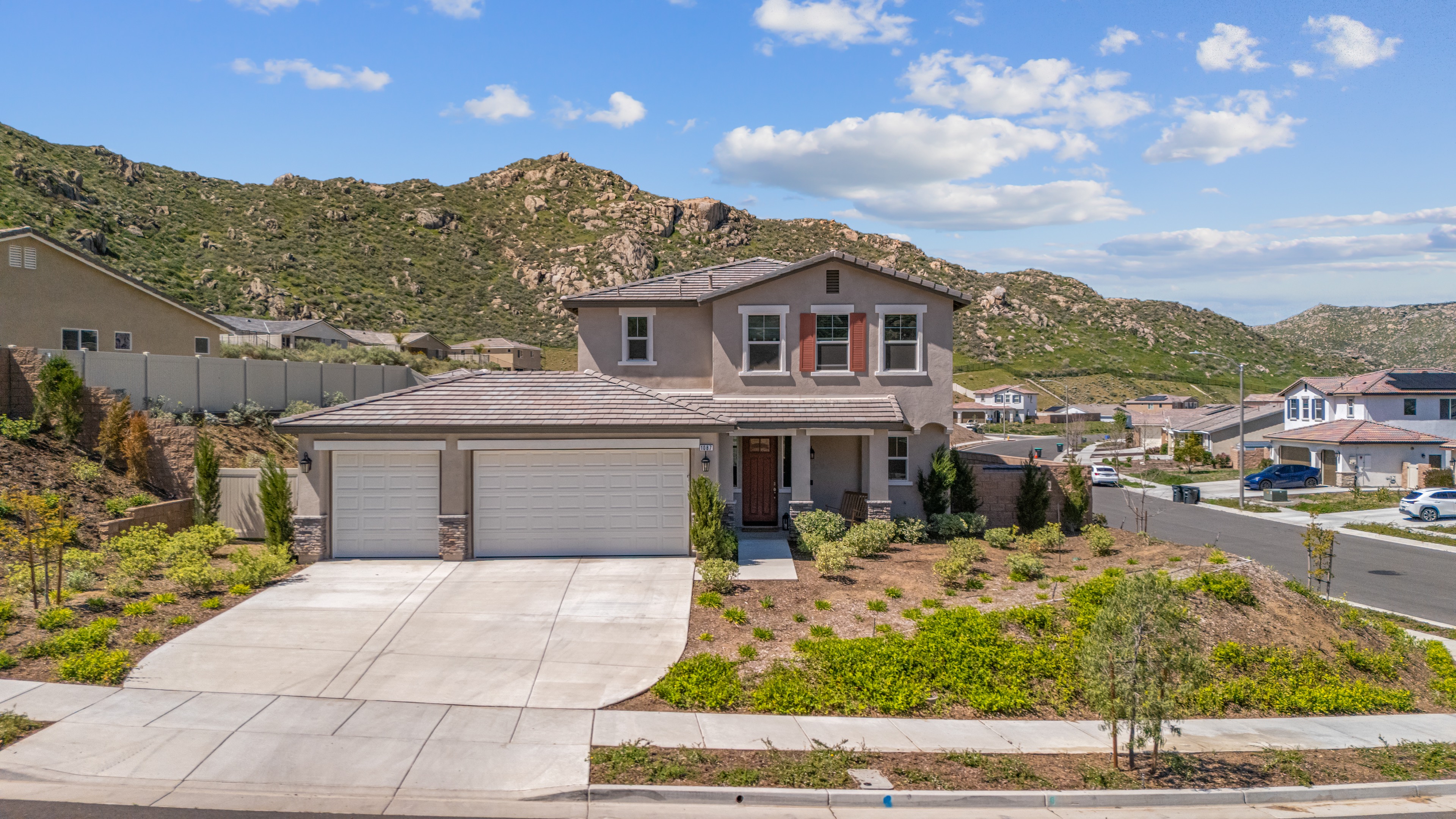 Aerial shot of hillside home with mountain views